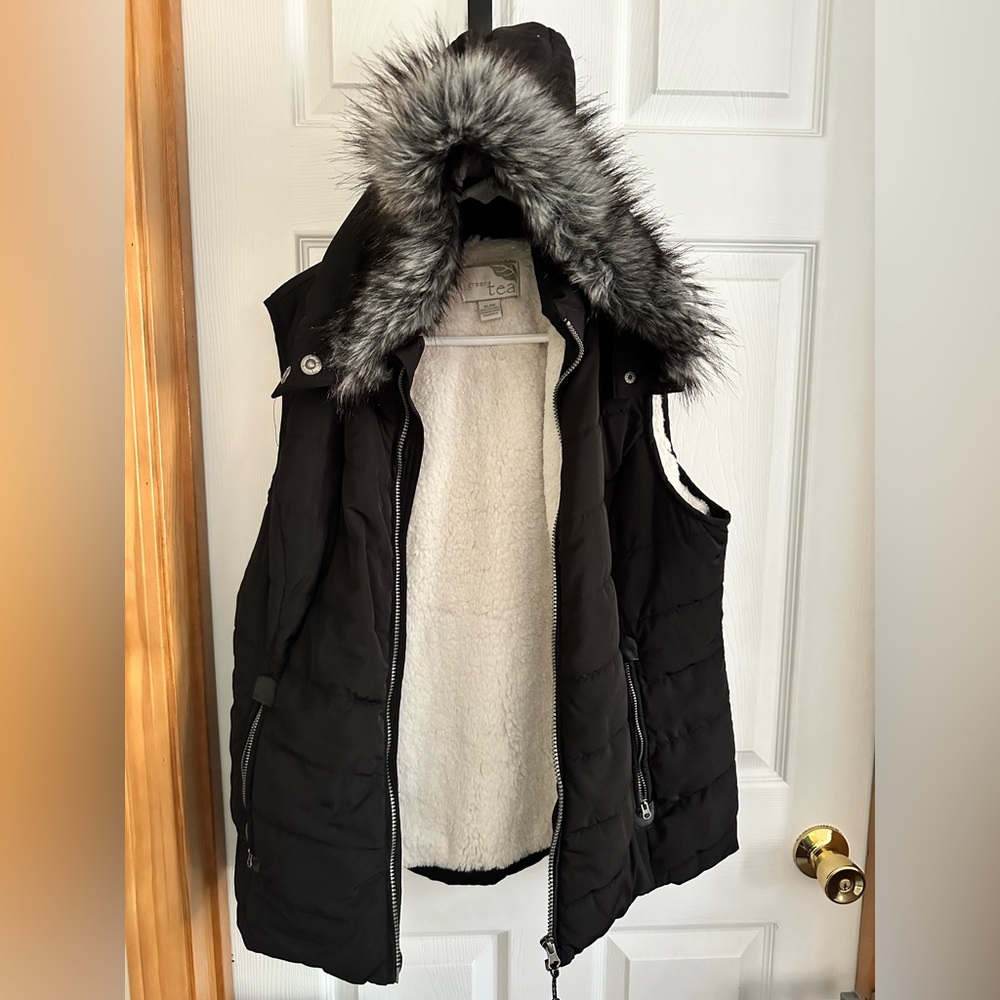 Black vest with fur hood. Green tea brand. Size XL